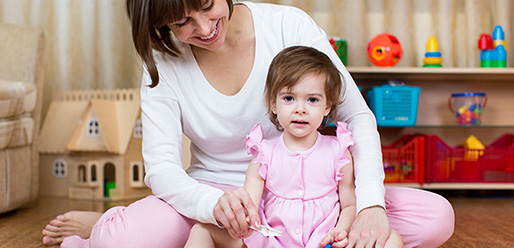 baby girl playing with mom